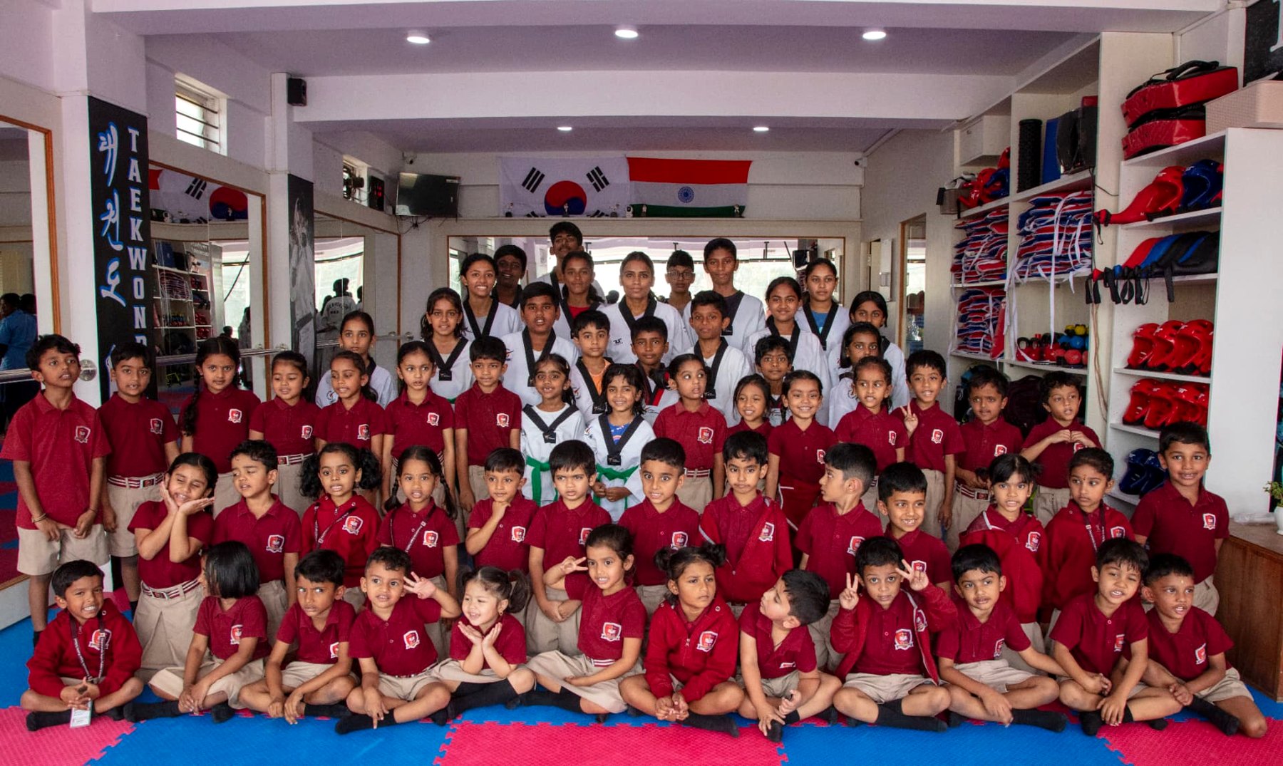 Full academy group photo with Master Tejashwini VN and students at the dojang
