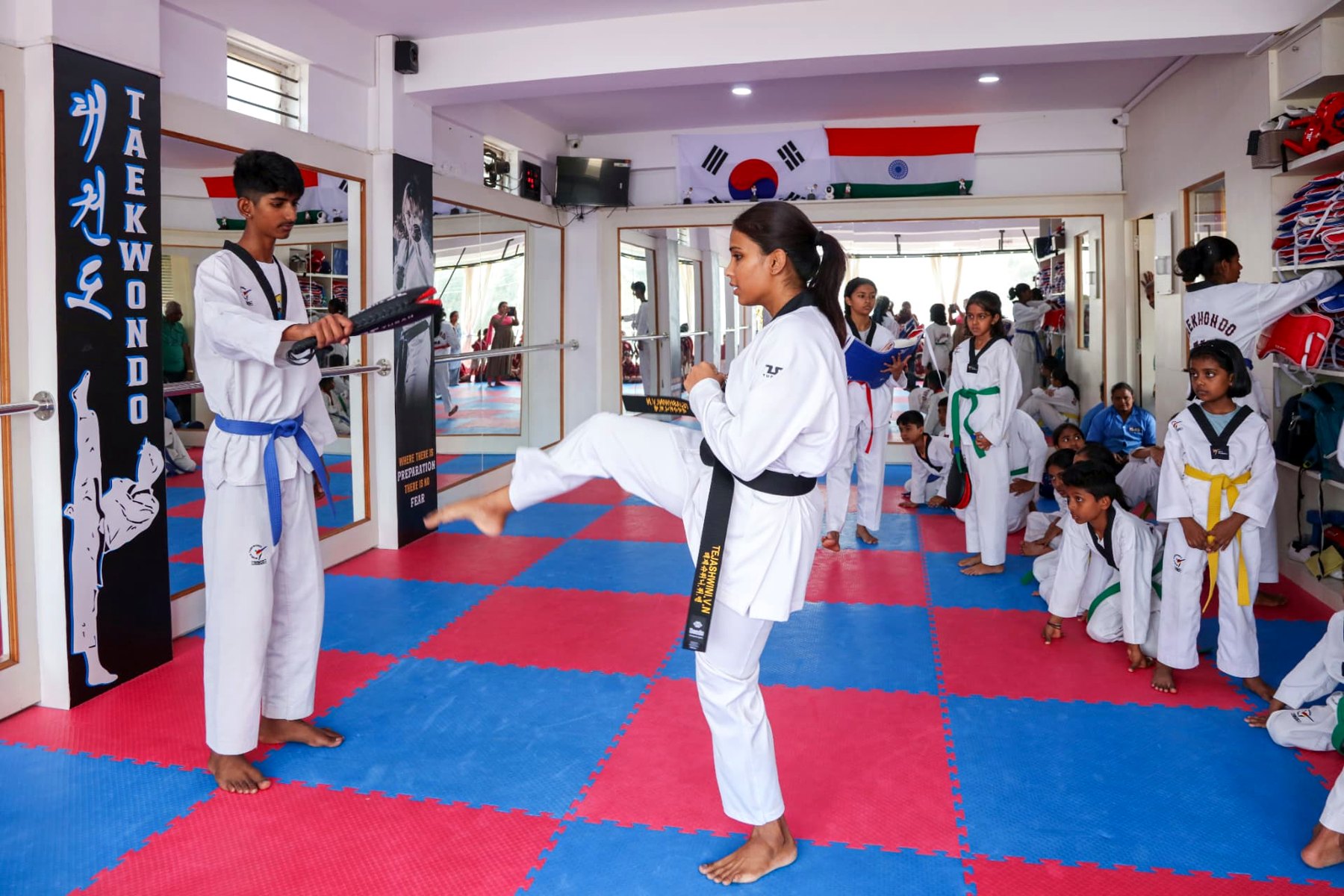 Master Tejashwini VN demonstrating a high kick on the paddle