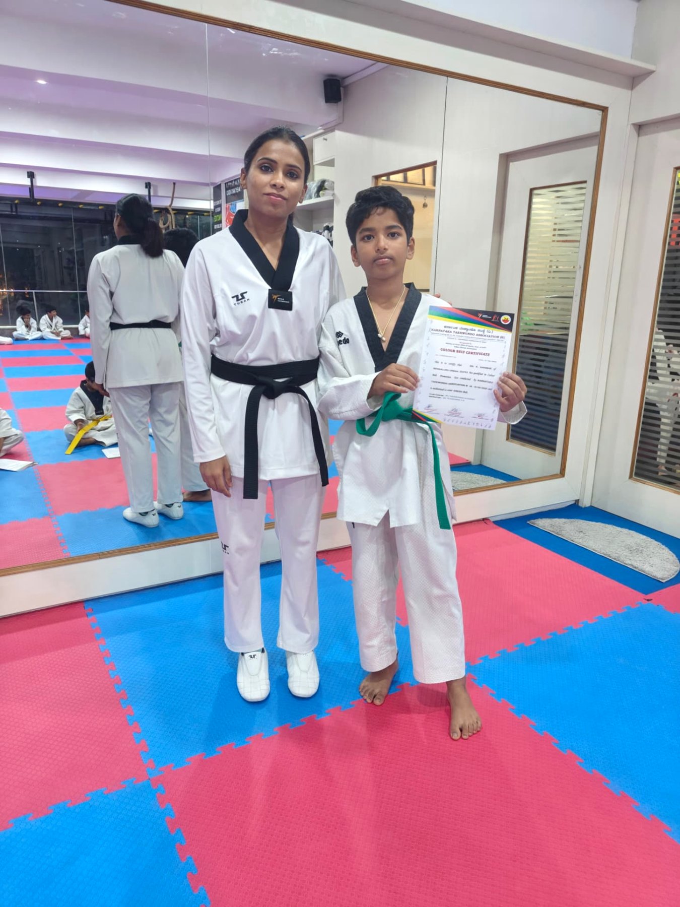 Green belt promotion — colour belt certificate with Master Tejashwini VN
