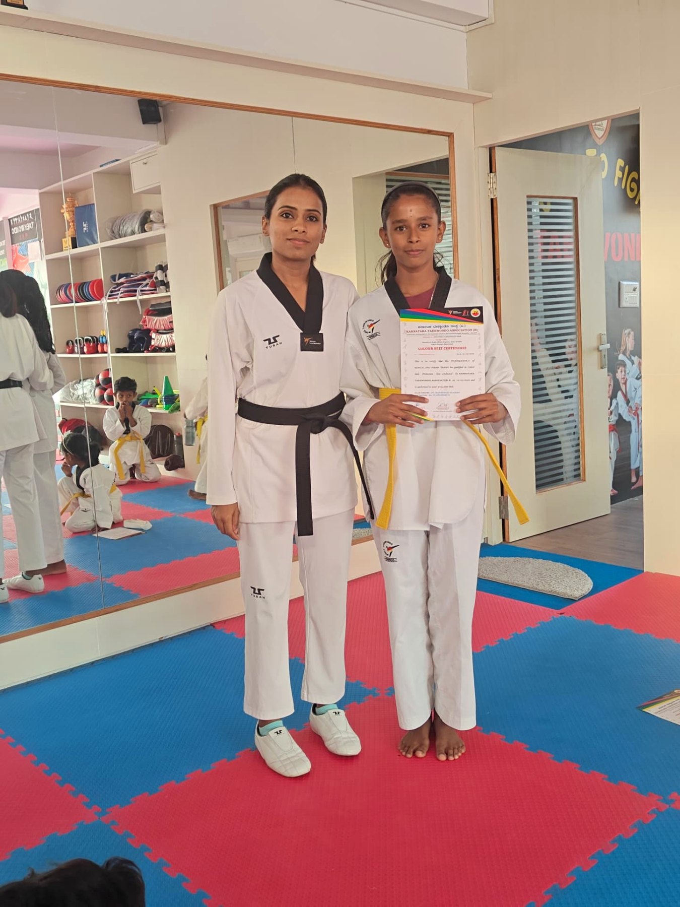Yellow belt grading certificate presented by Master Tejashwini VN