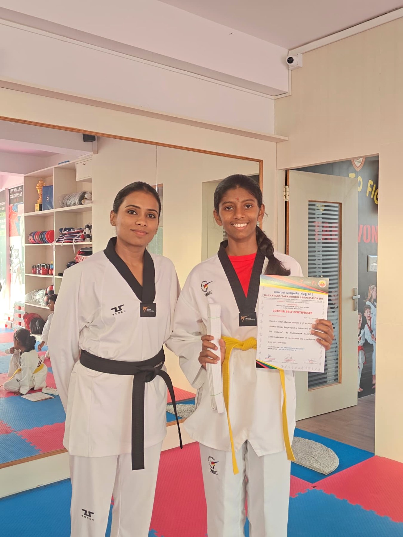 Colour belt certificate presented to a yellow belt student by the master