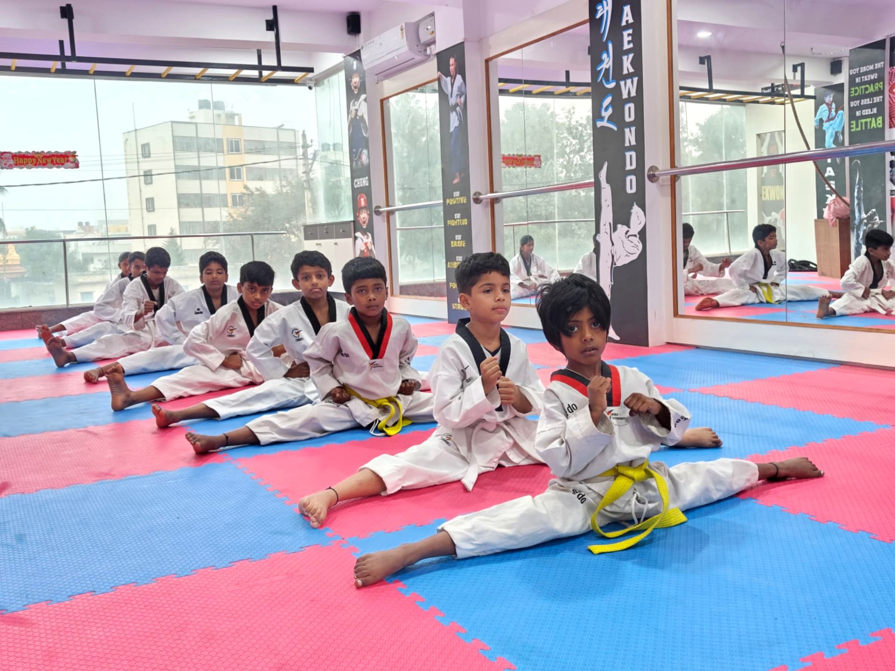 Young warriors holding the front split during flexibility training