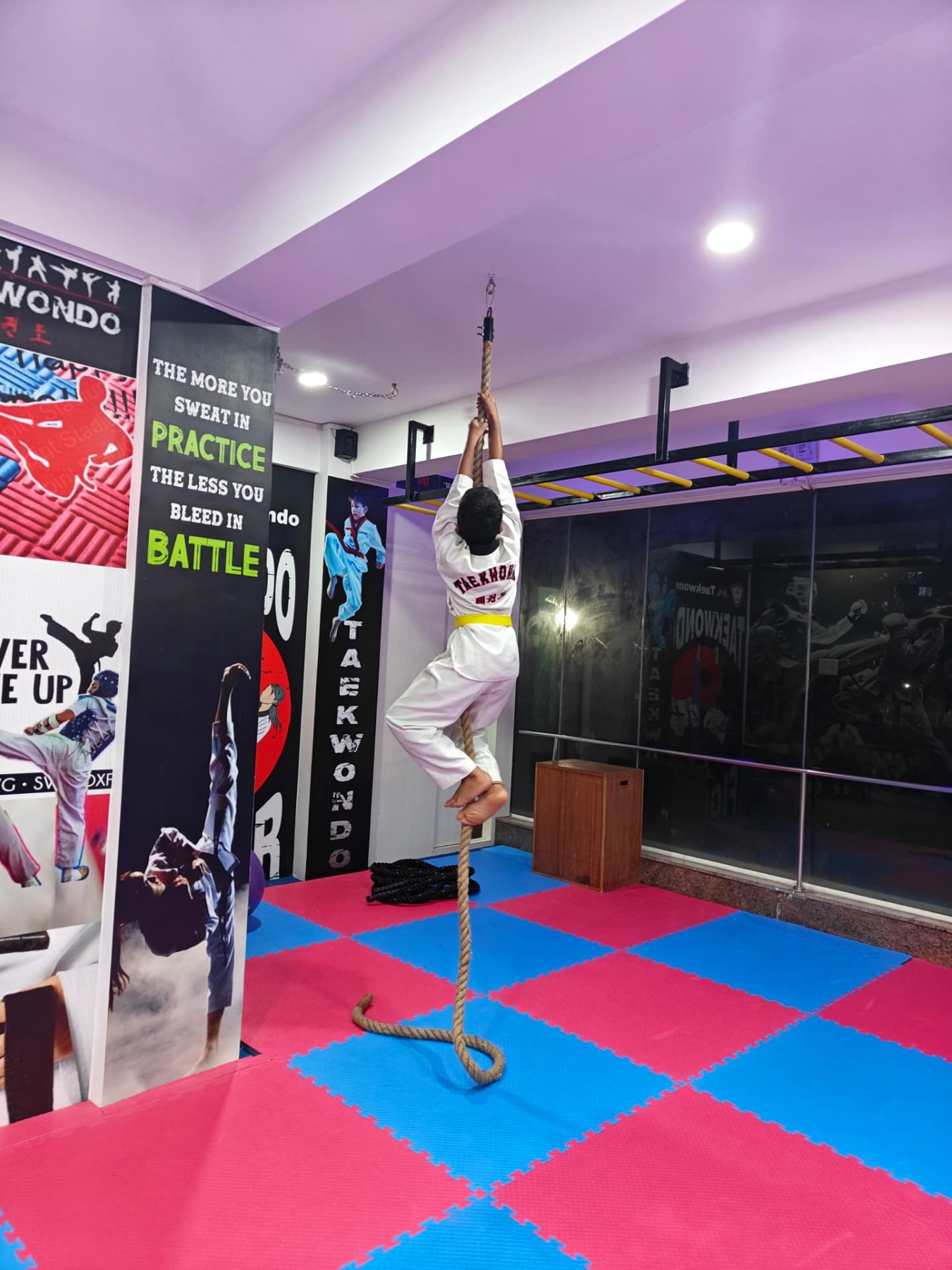 Junior student climbing the rope during strength and conditioning