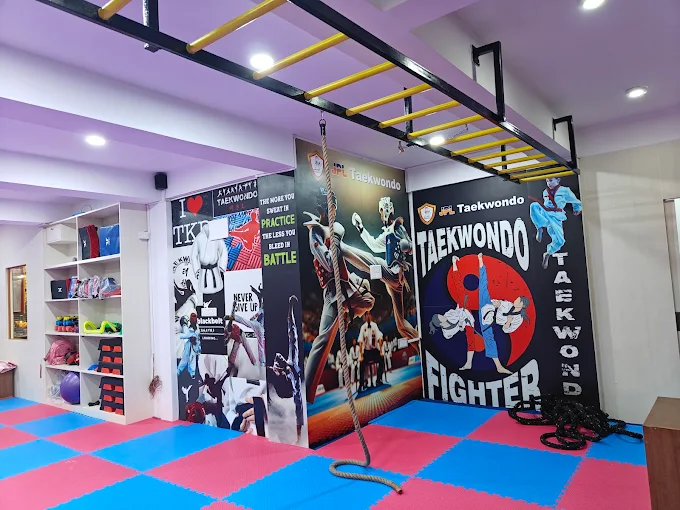 JPL Taekwondo Academy training hall with murals and monkey bars