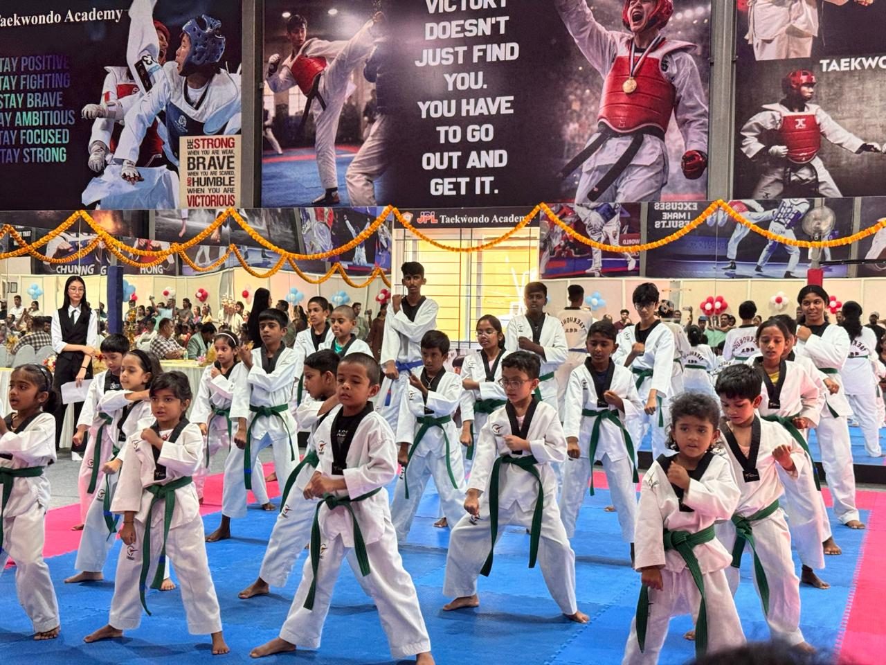 Green belt students performing a demonstration on the new mats
