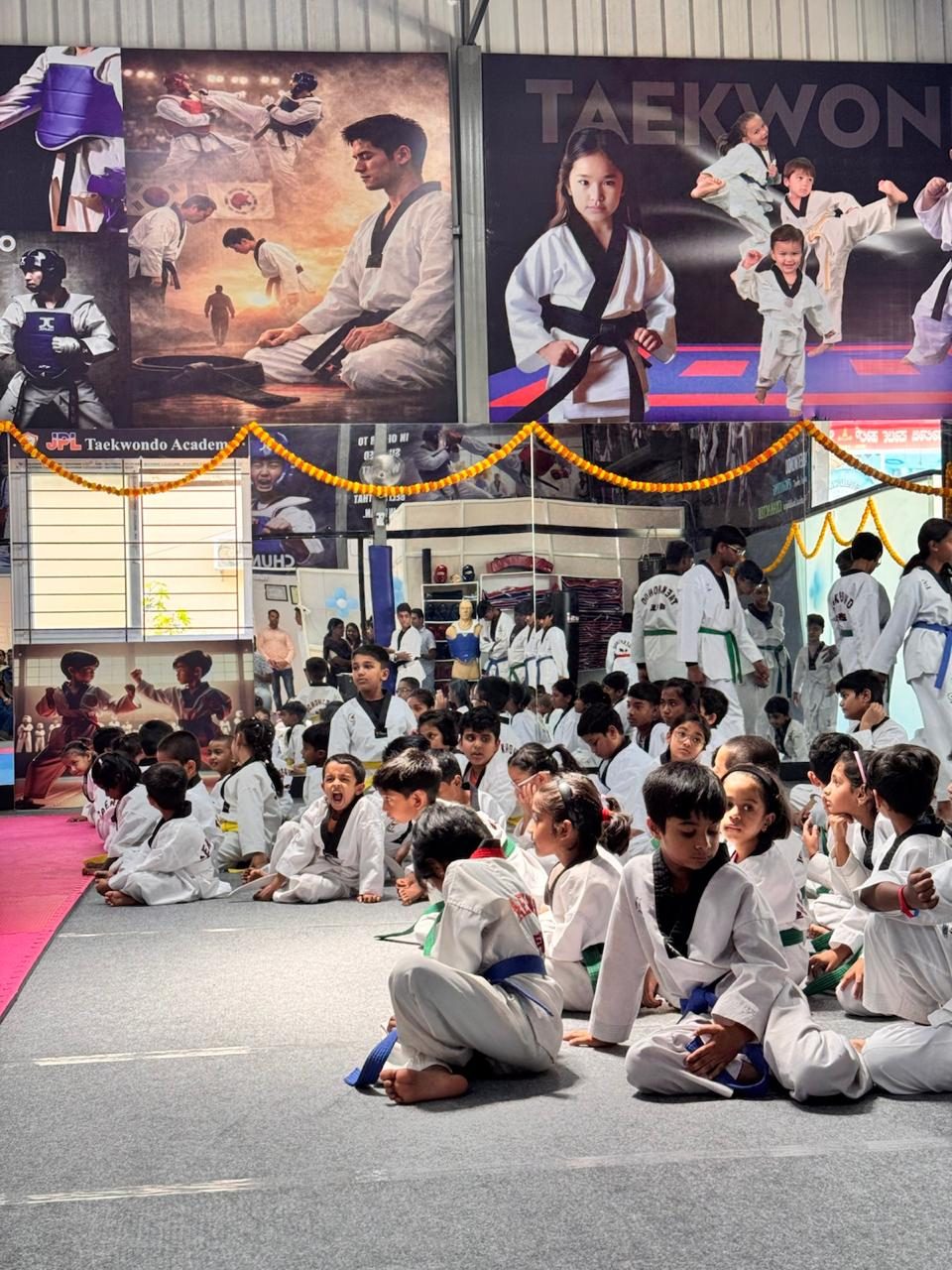 Young warriors watching the demonstrations from the training floor
