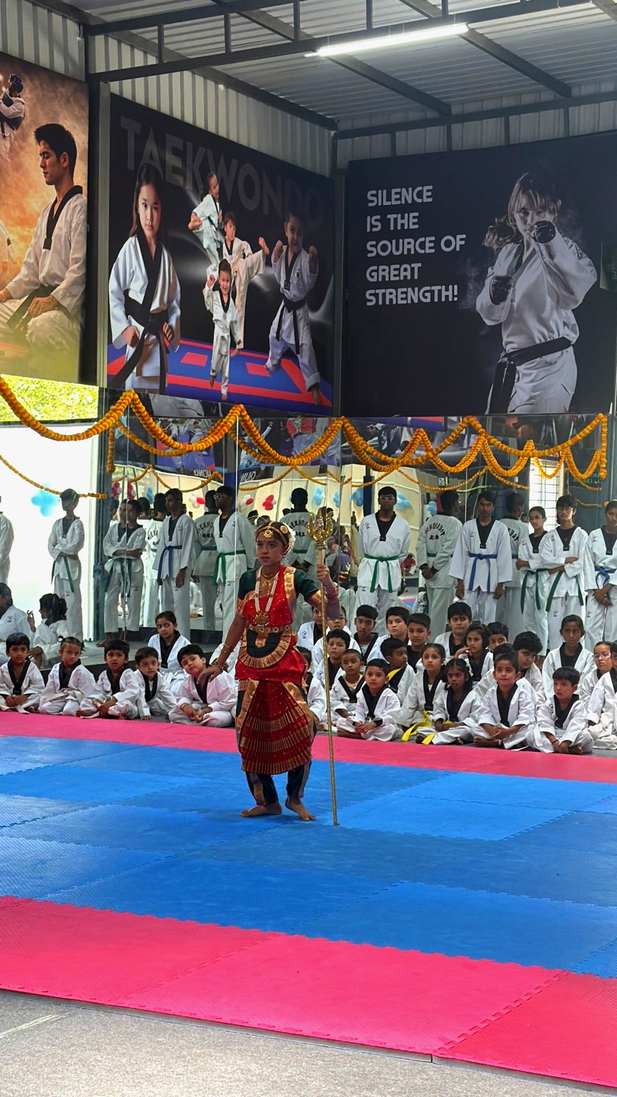 Bharatanatyam performance on the new mats as students watch on
