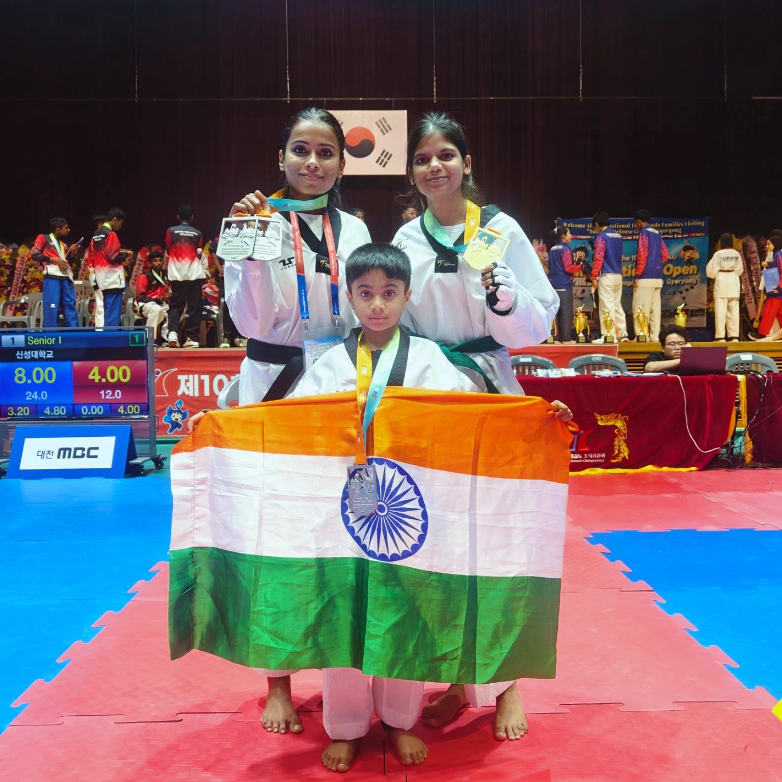 Team India with medals and the tricolour at Gyeryong Civic Gymnasium