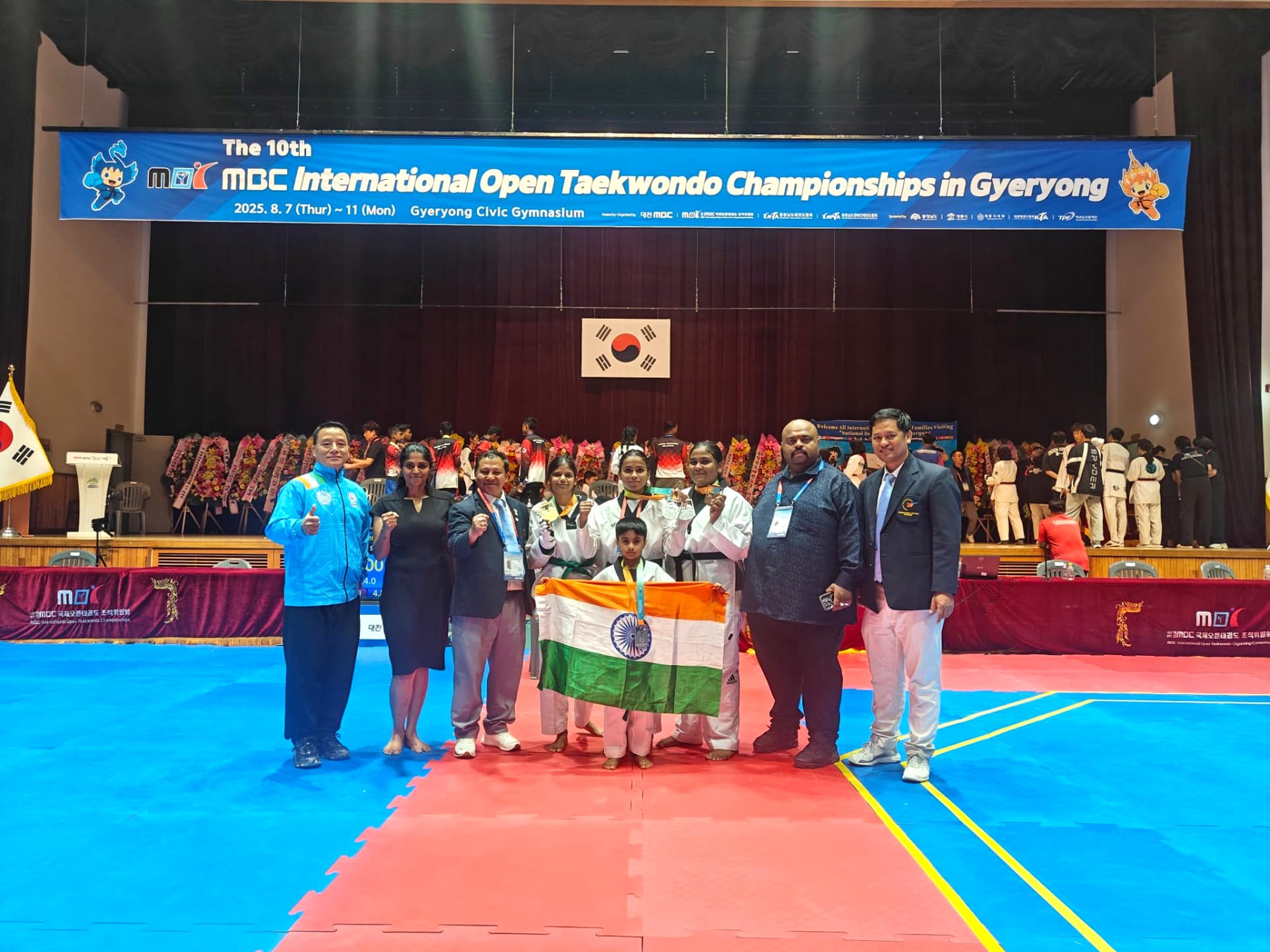 Team India medallists with coaches and officials on the championship mat
